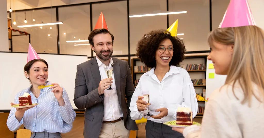 Happy employee unwrapping a birthday gift in the office, promoting workplace motivation and camaraderie.
